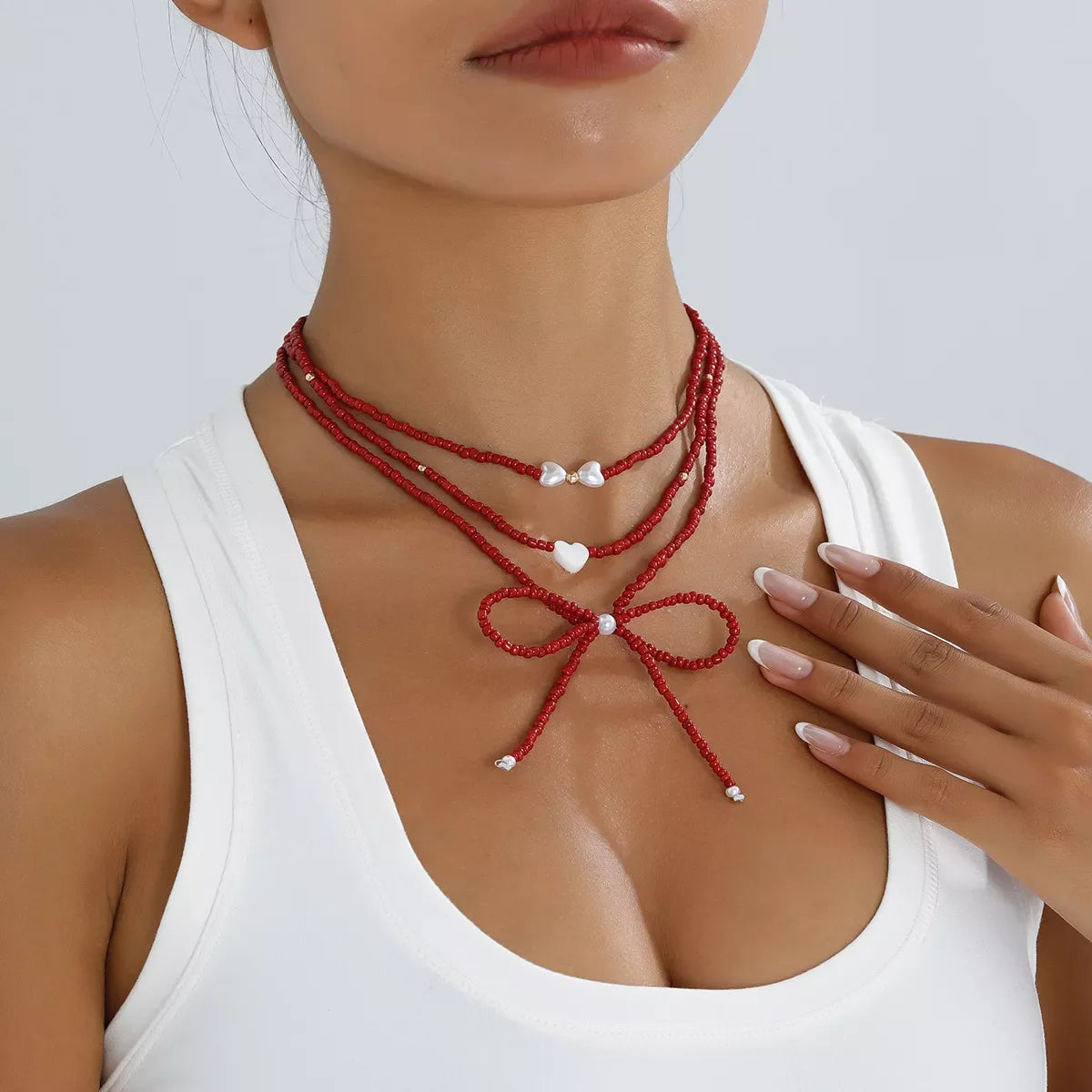 Beaded Bow Necklace with Heart Pendants