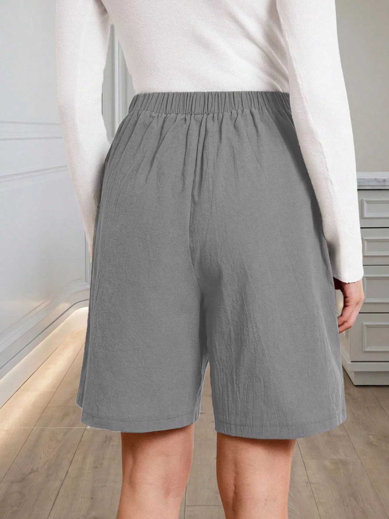 High-Waisted Pleated Shorts with Button Detail
