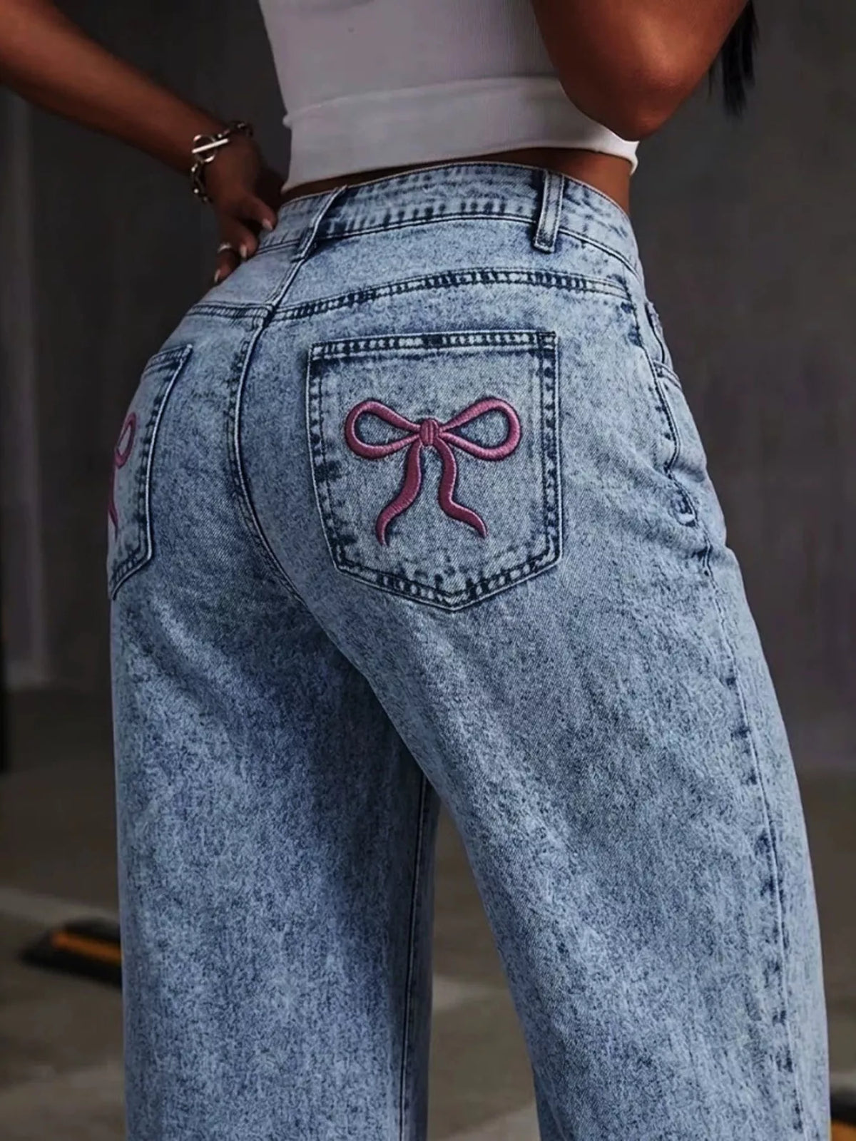 Washed Wide Leg Jeans with Embroidered Bow Detail