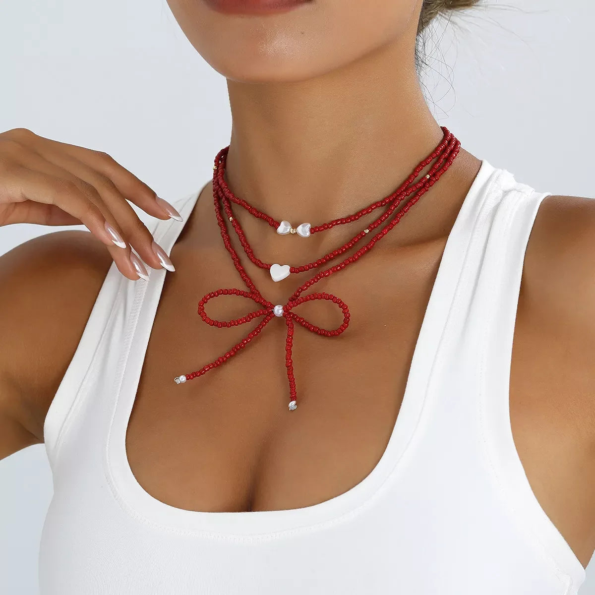 Beaded Bow Necklace with Heart Pendants