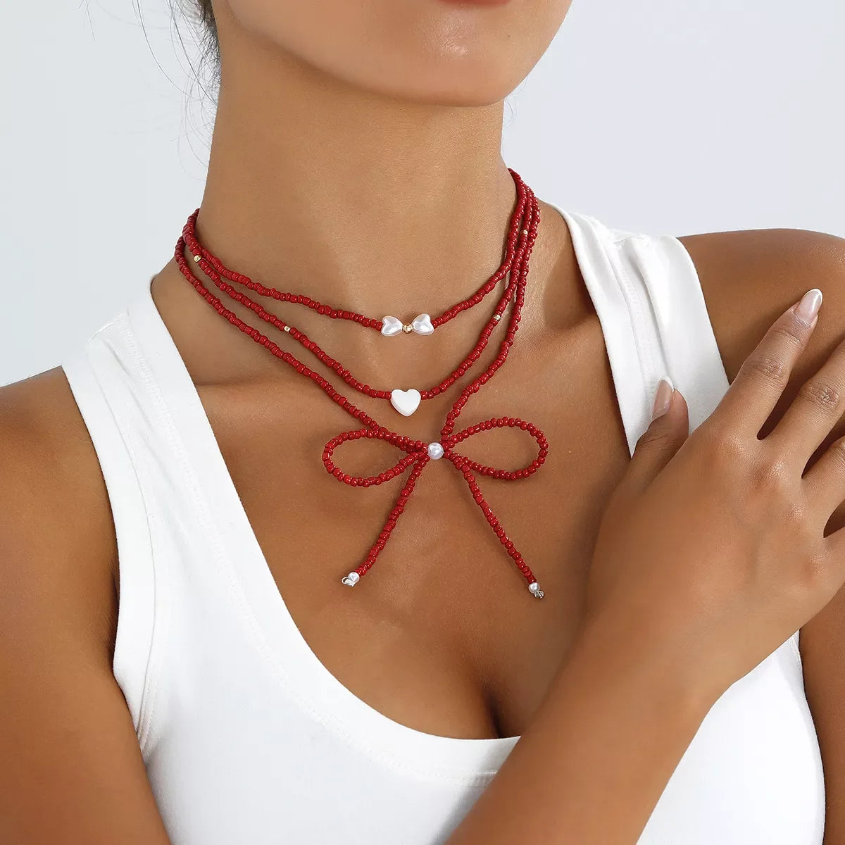 Beaded Bow Necklace with Heart Pendants